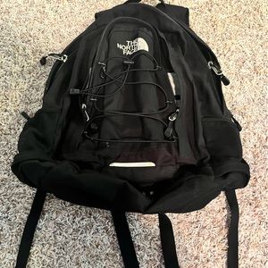 Black Northface backpack. Loads of pockets and drink holders on the side